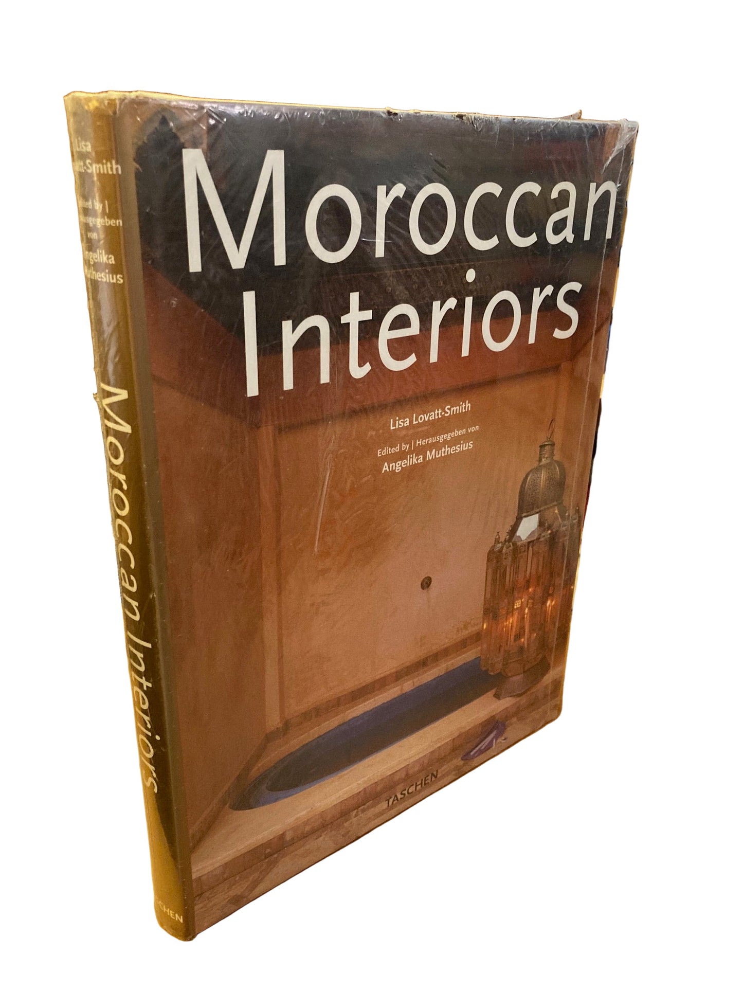 Book titled 'Moroccan Interiors' on a wooden surface
