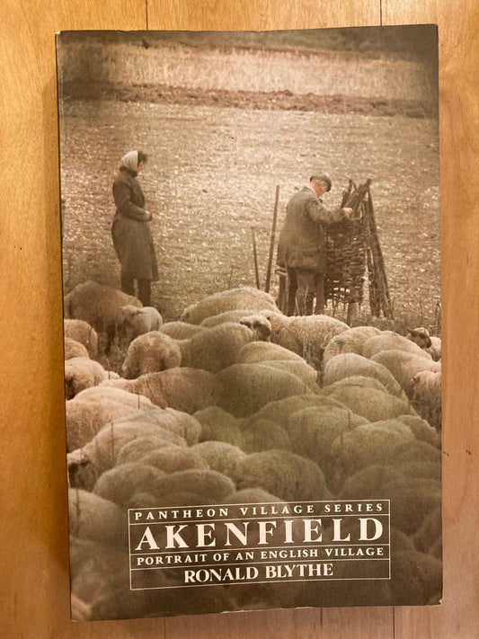 Book cover of 'Akenfield' by Ronald Bythe on a wooden surface